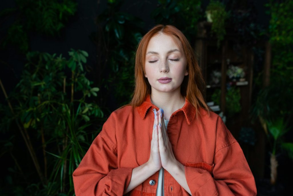 Woman meditating with namaste hands